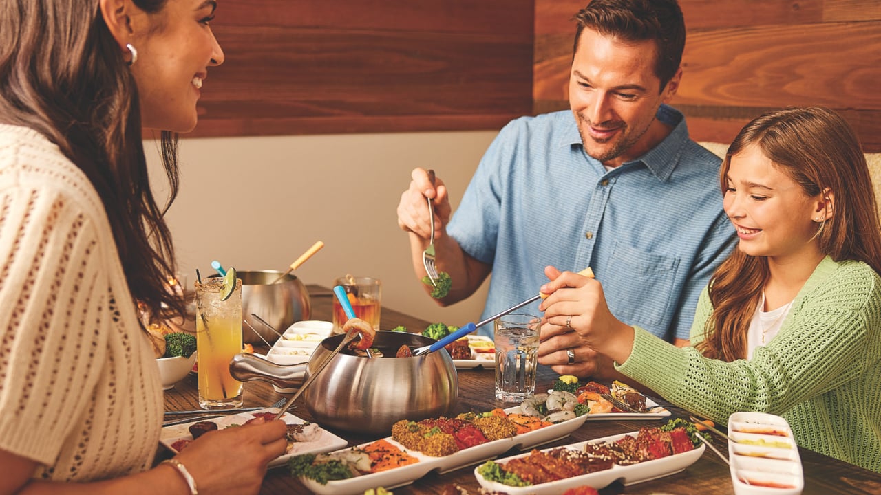 family enjoying The Melting Pot