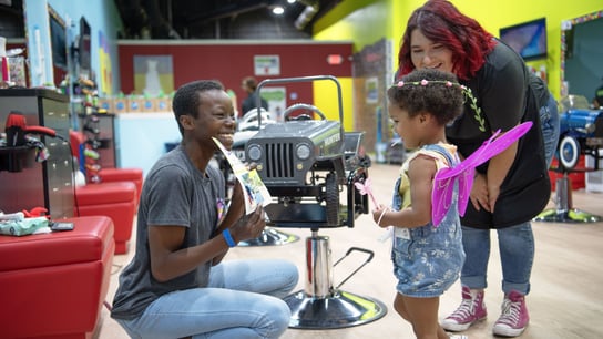 Photo of kid and stylists at Pigtails & Crewcuts