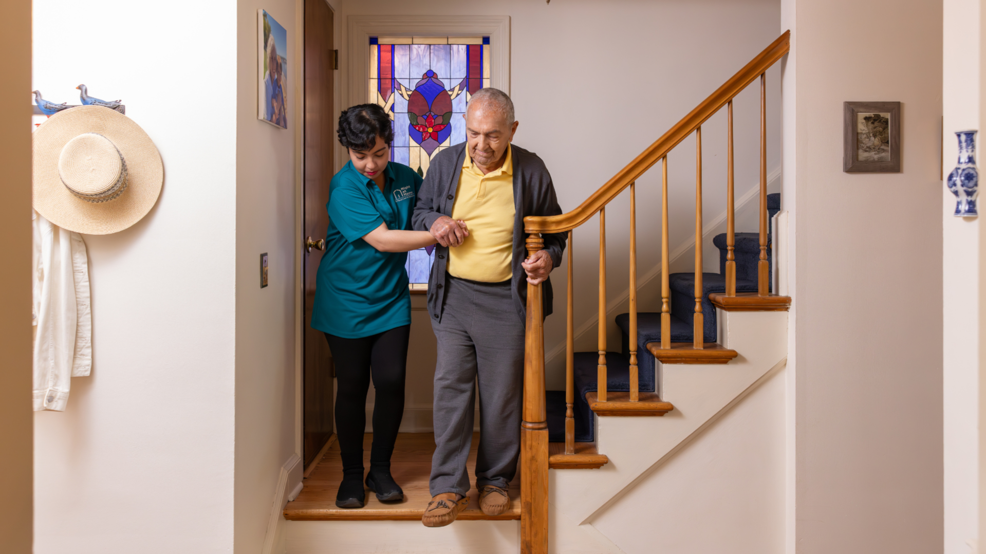 Photo of Right at Home caregiver and client descending stairs