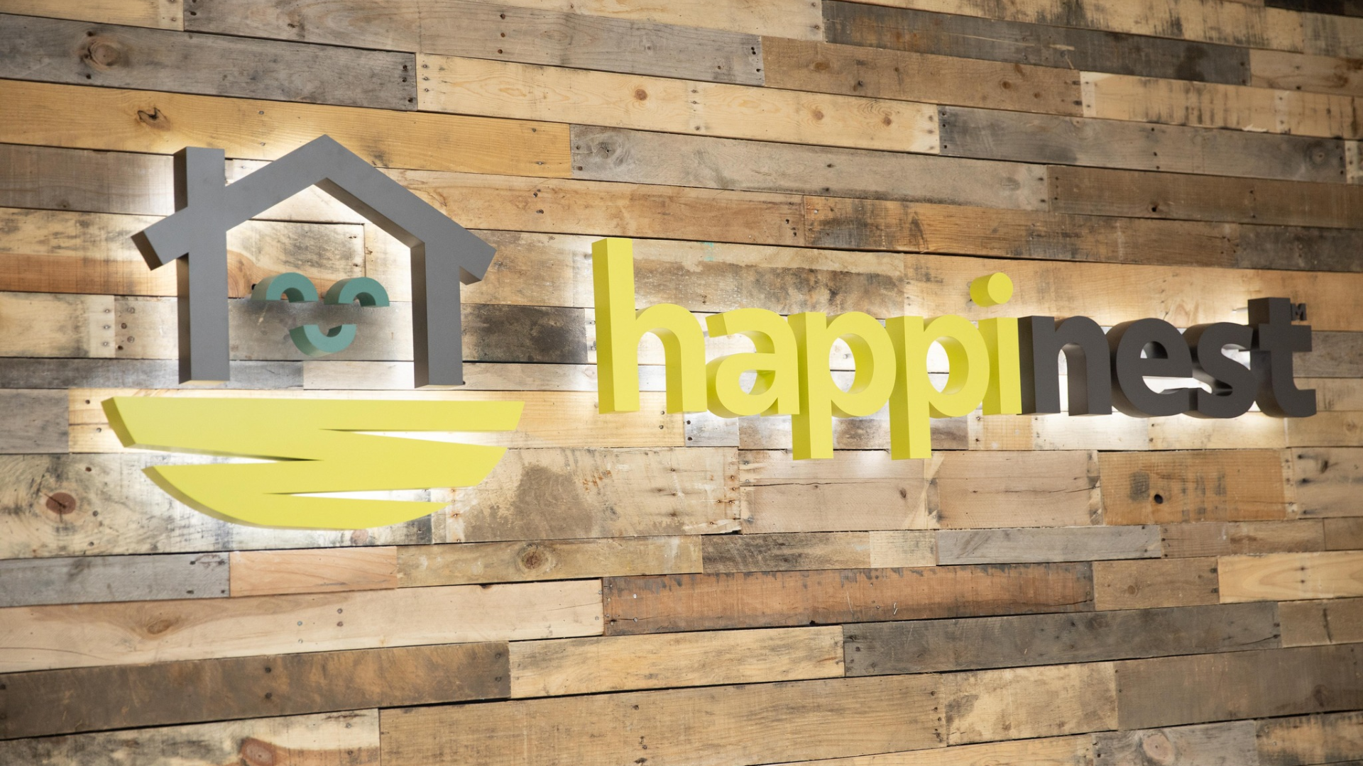 image of a happiness business franchise logo on a wood wall on location