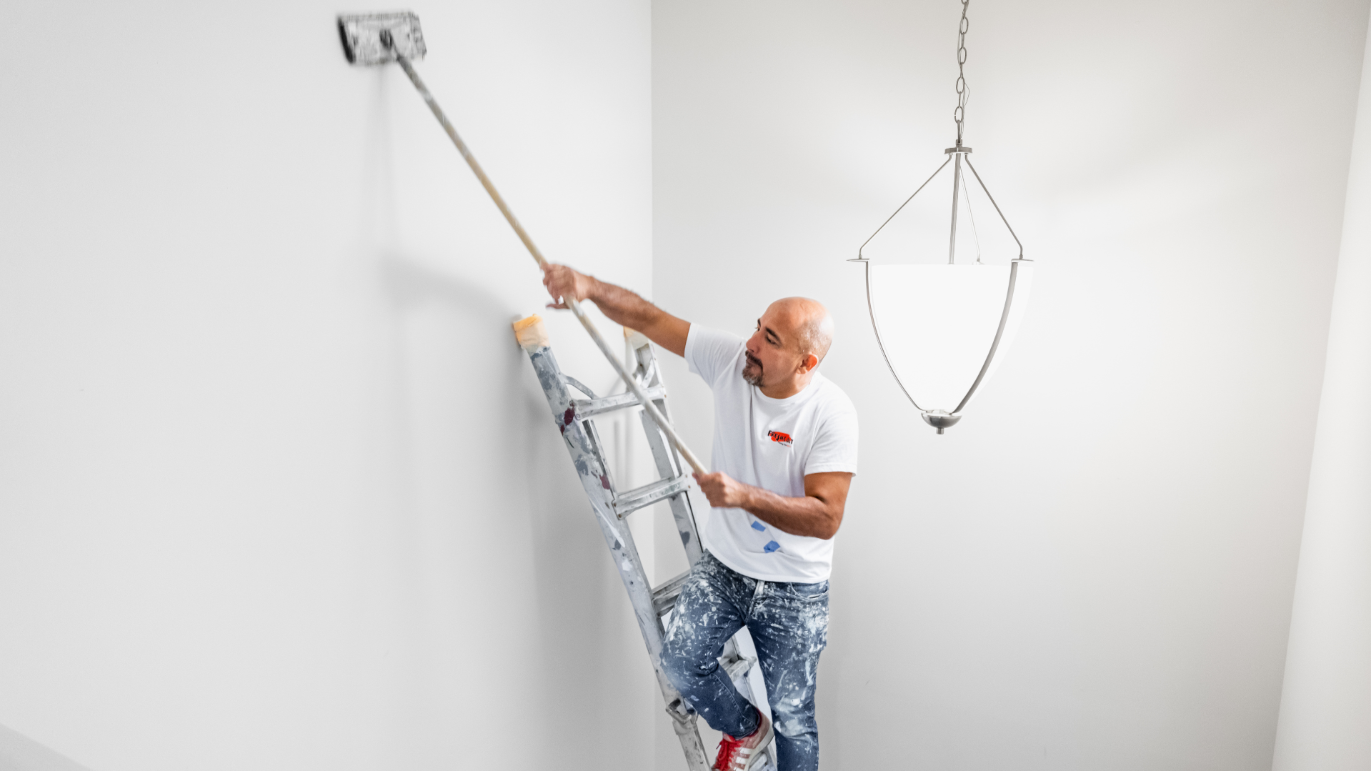 Photo of Fresh Coat Painters team member working on ladder