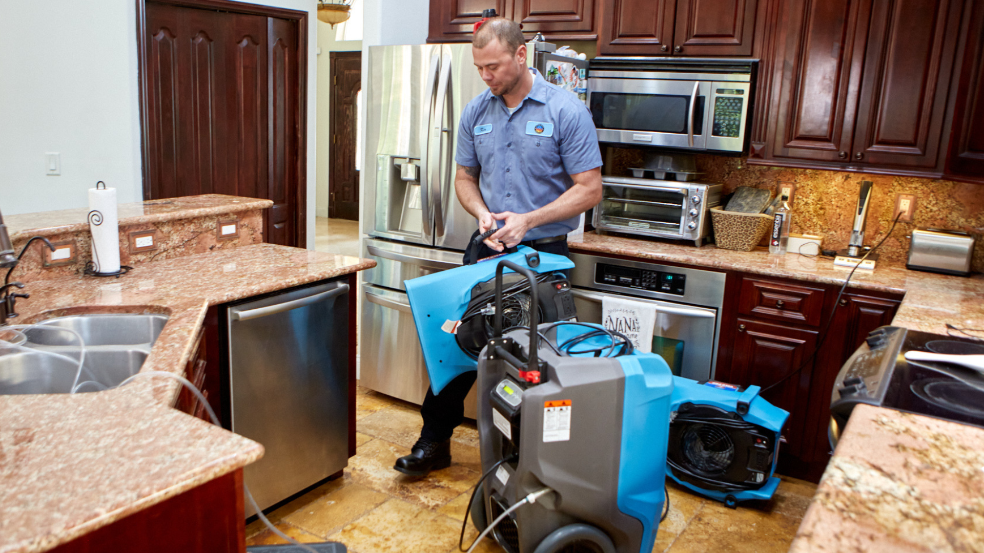 Photo of United Water Restoration Group team member working in kitchen