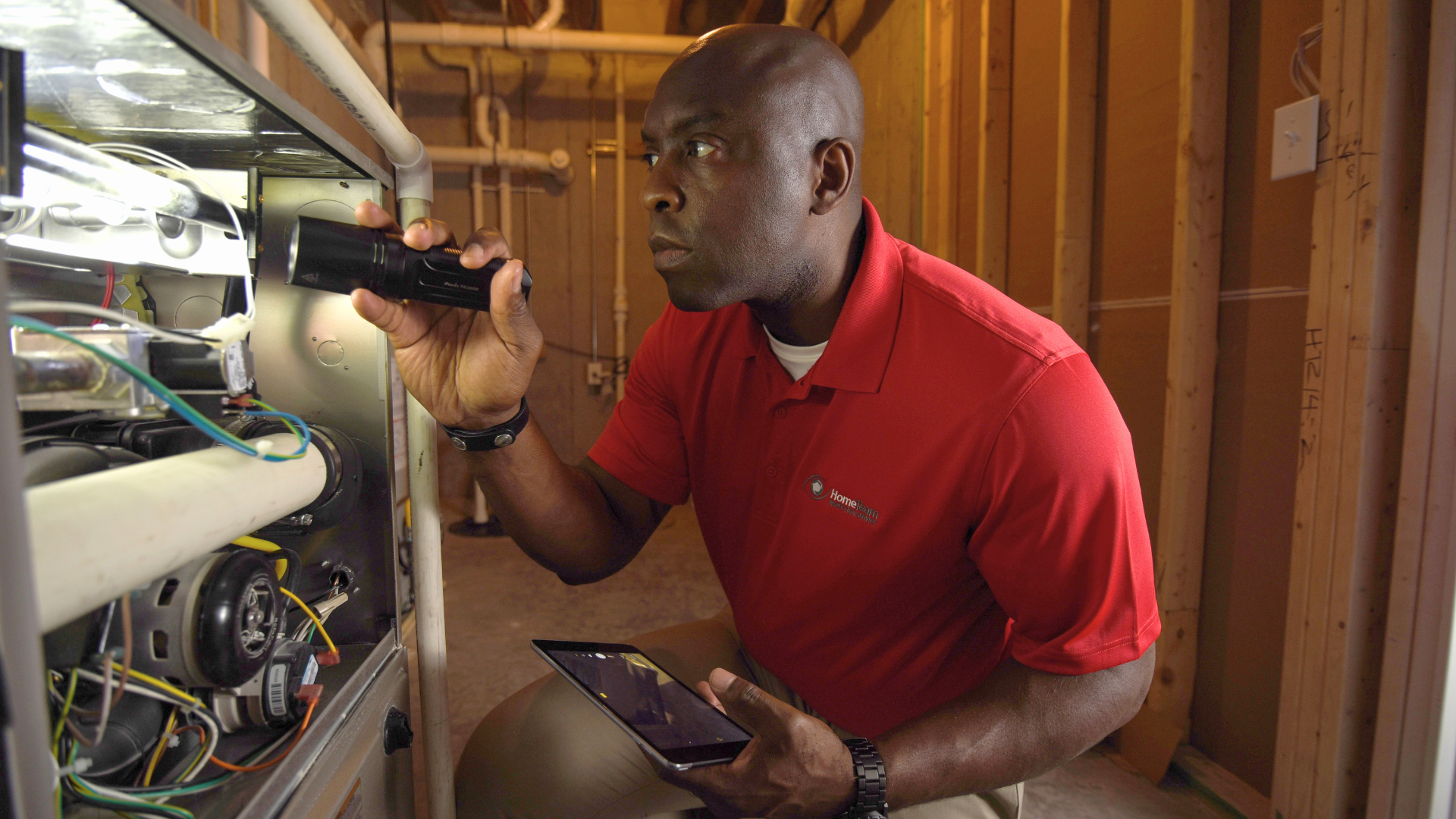Photo of HomeTeam inspector carrying flashlight and tablet