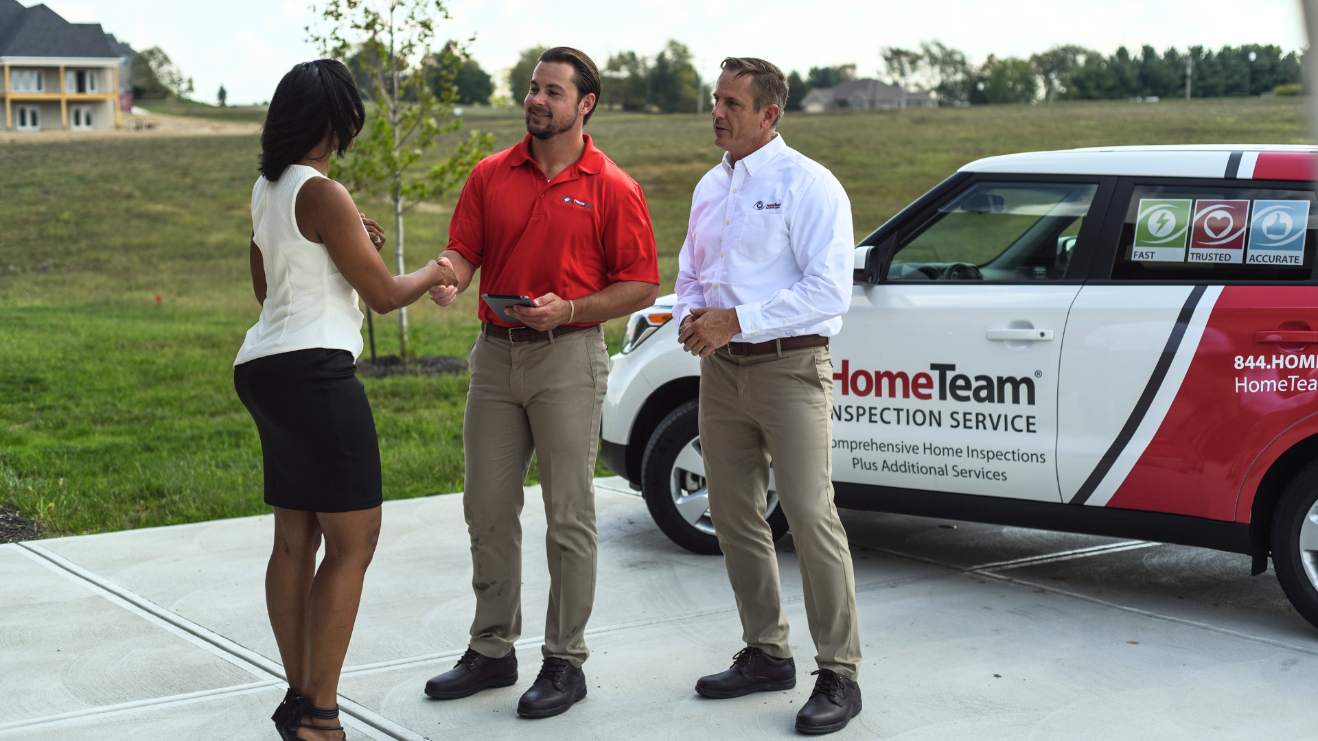 Photo of HomeTeam Inspection Service team speaking with client 