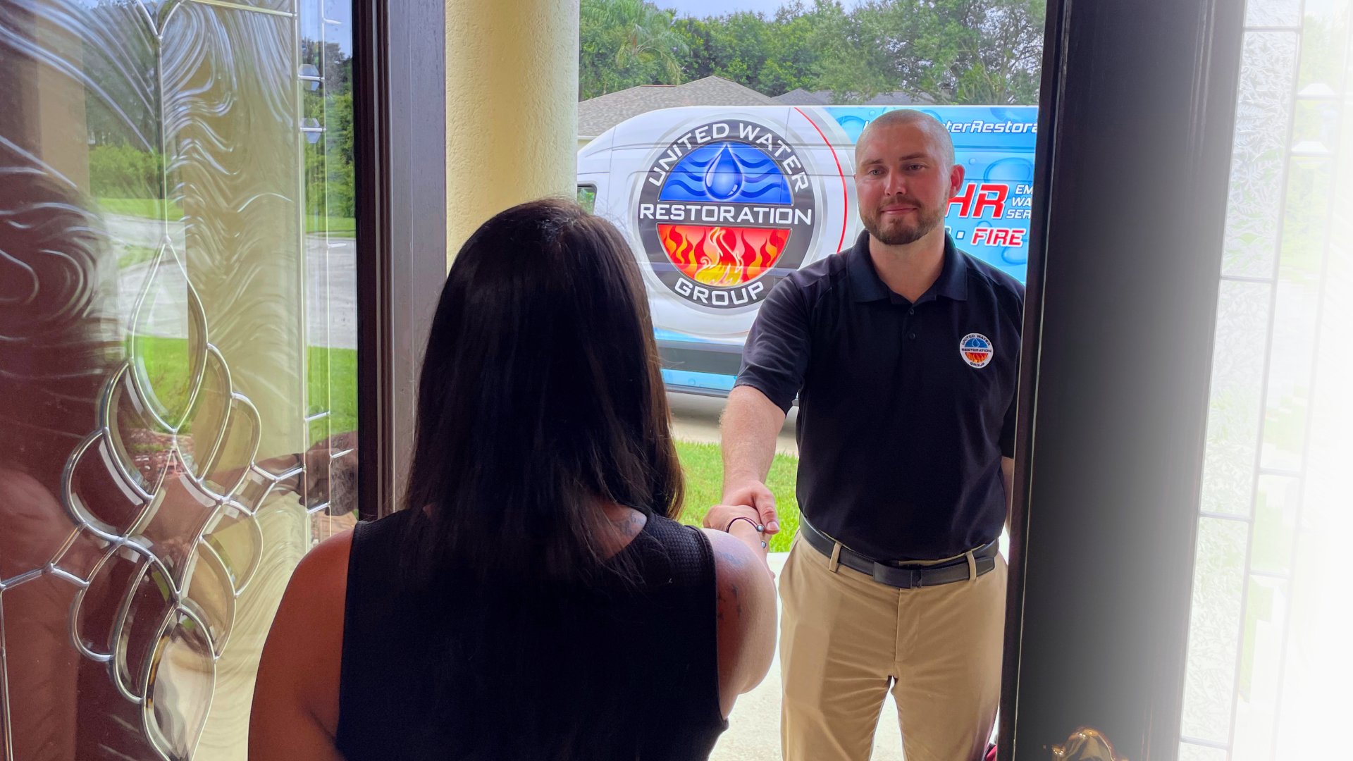 Photo of UWRG team member shaking homeowner's hand